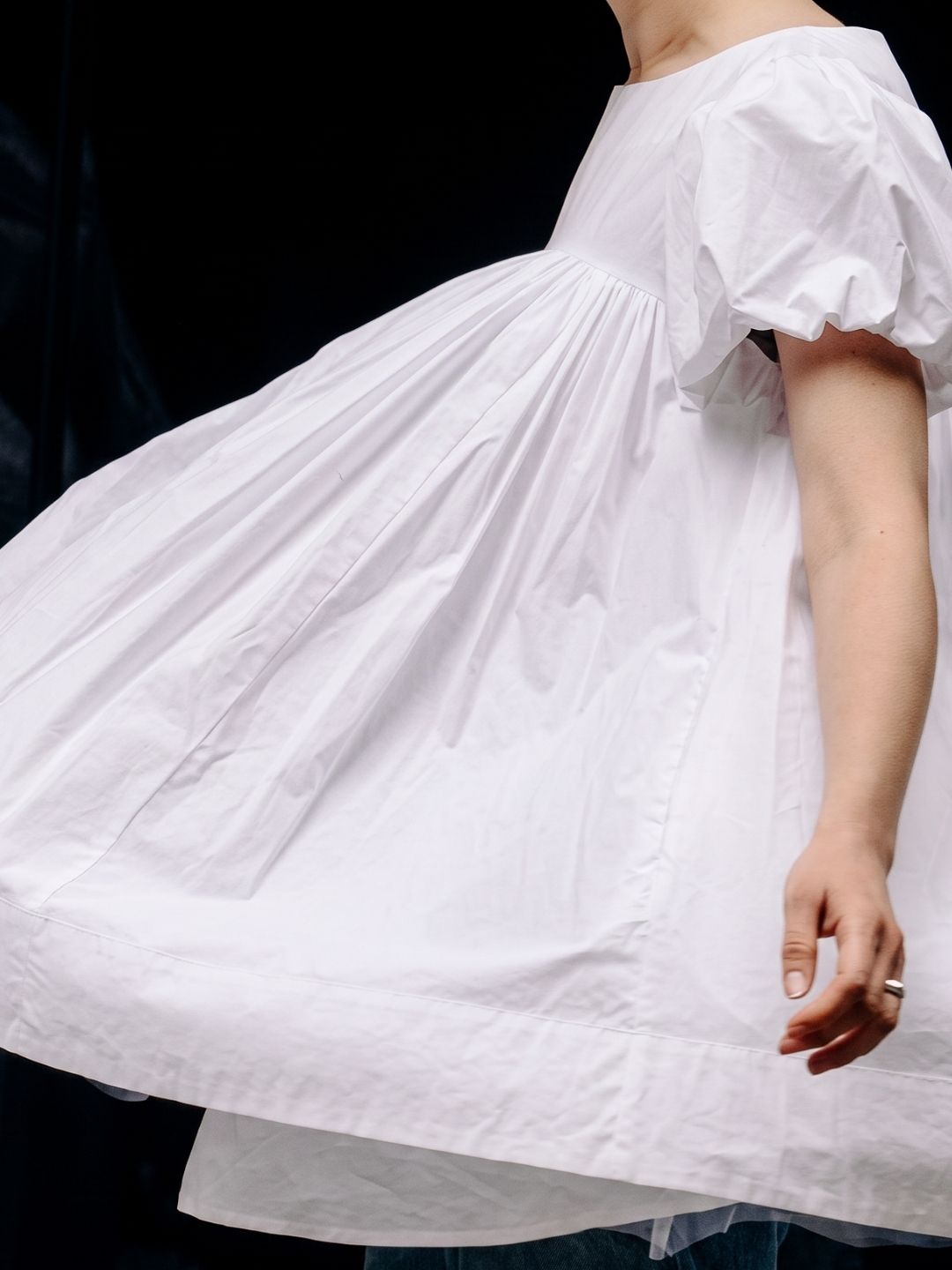 A person spinning in her white baby doll top.