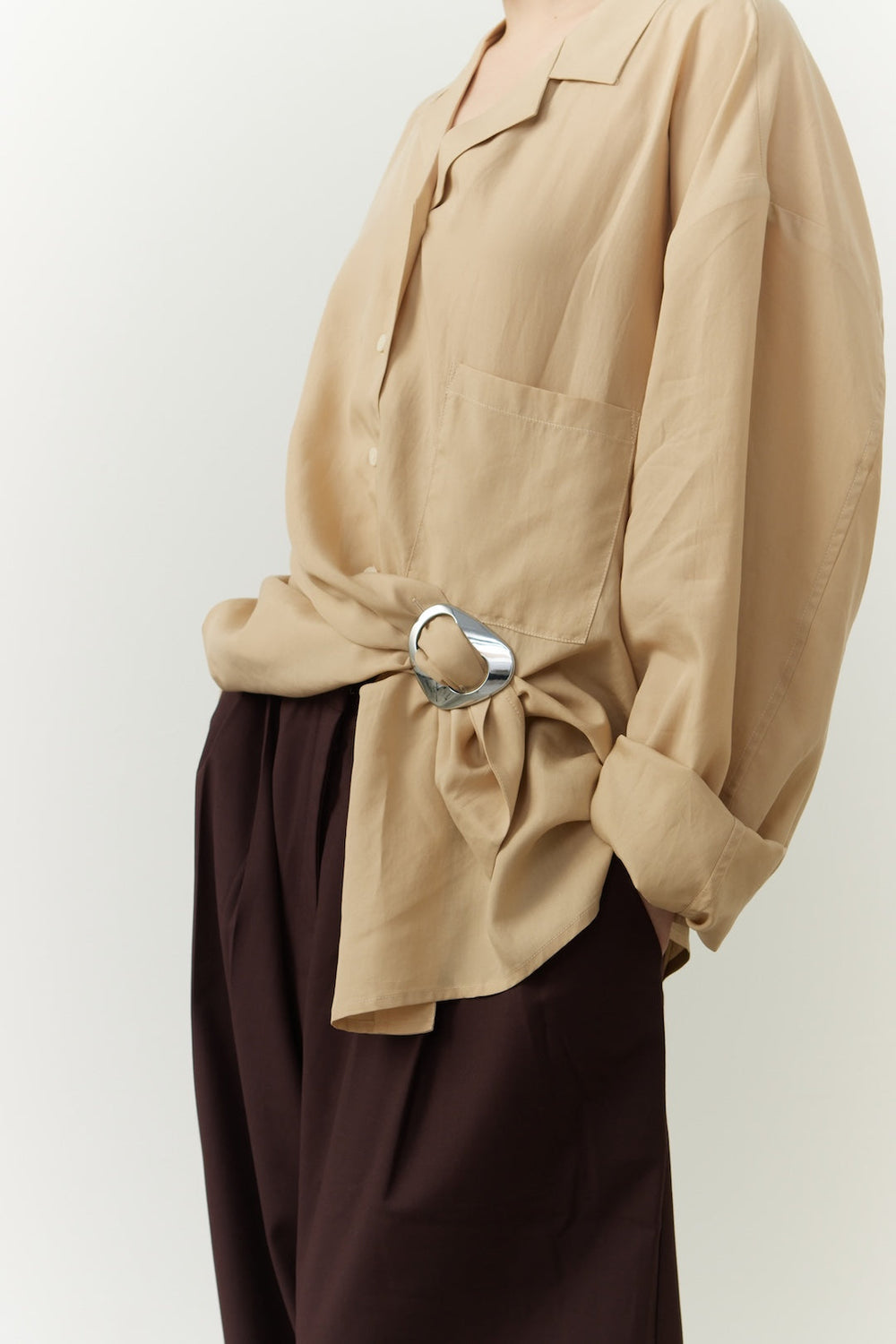 Camel-colored shirt styled with a Kitdo's MagniClip in Sterling Silver at the waist. Completed with burgundy pants.