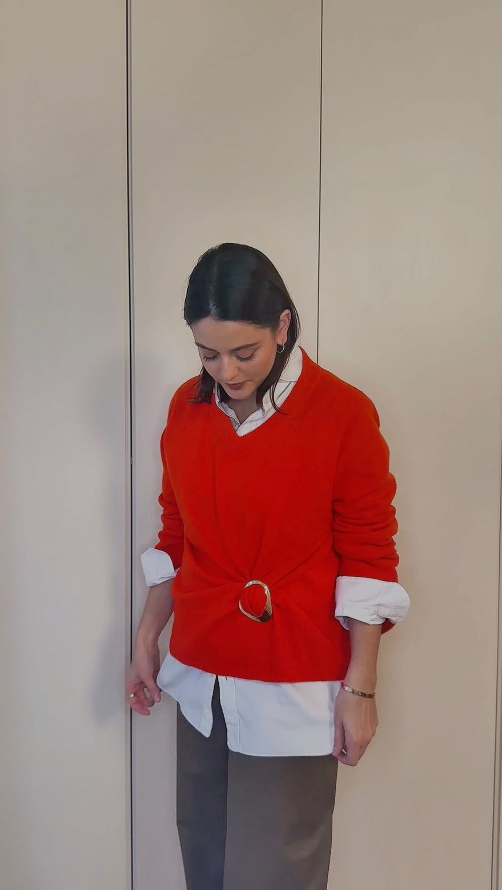 Fashion stylist using magnetic clothing clip on her sweater