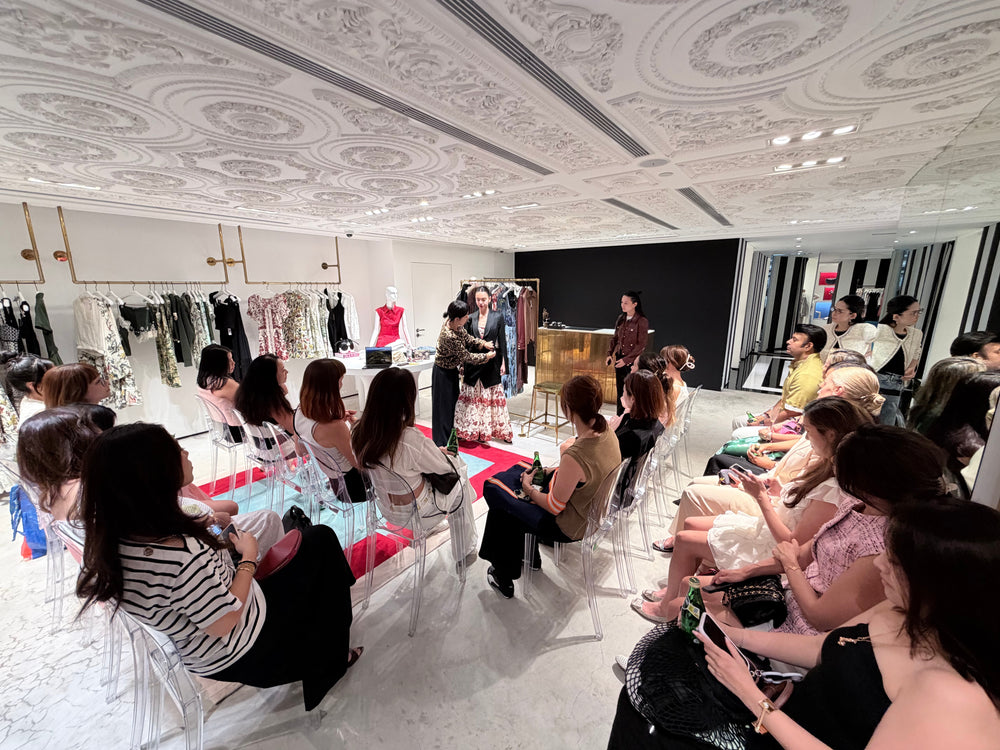 A live styling presentation with an audience at a premium clothing store.