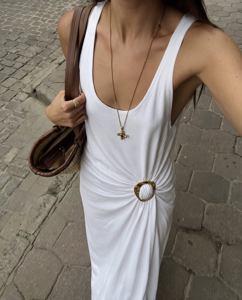 Woman in a white maxi dress adorned with a MagniClip Glossy Glow by Kitdo at the waist.